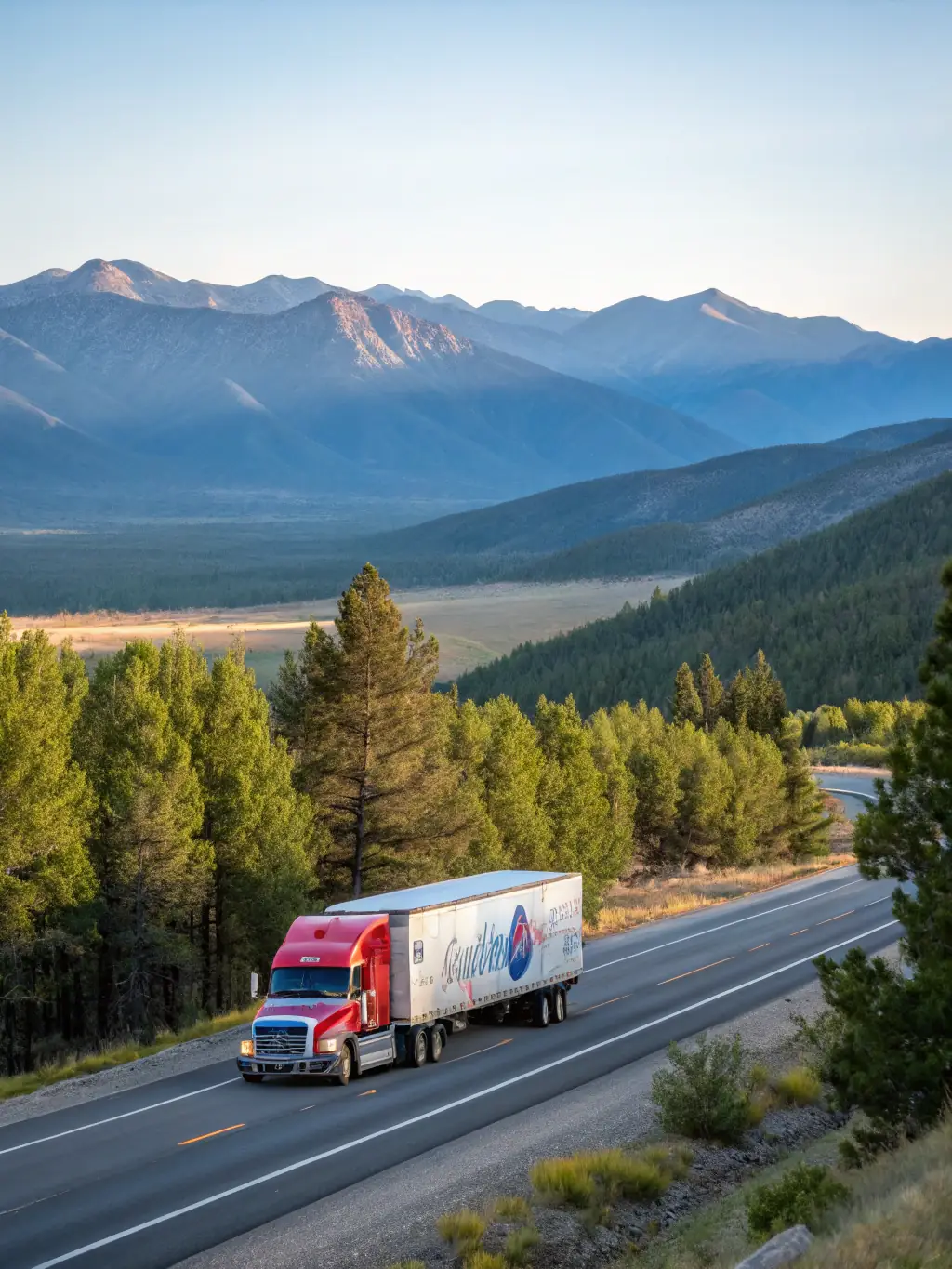 A FreightFusion truck driving on a highway with mountains in the background.